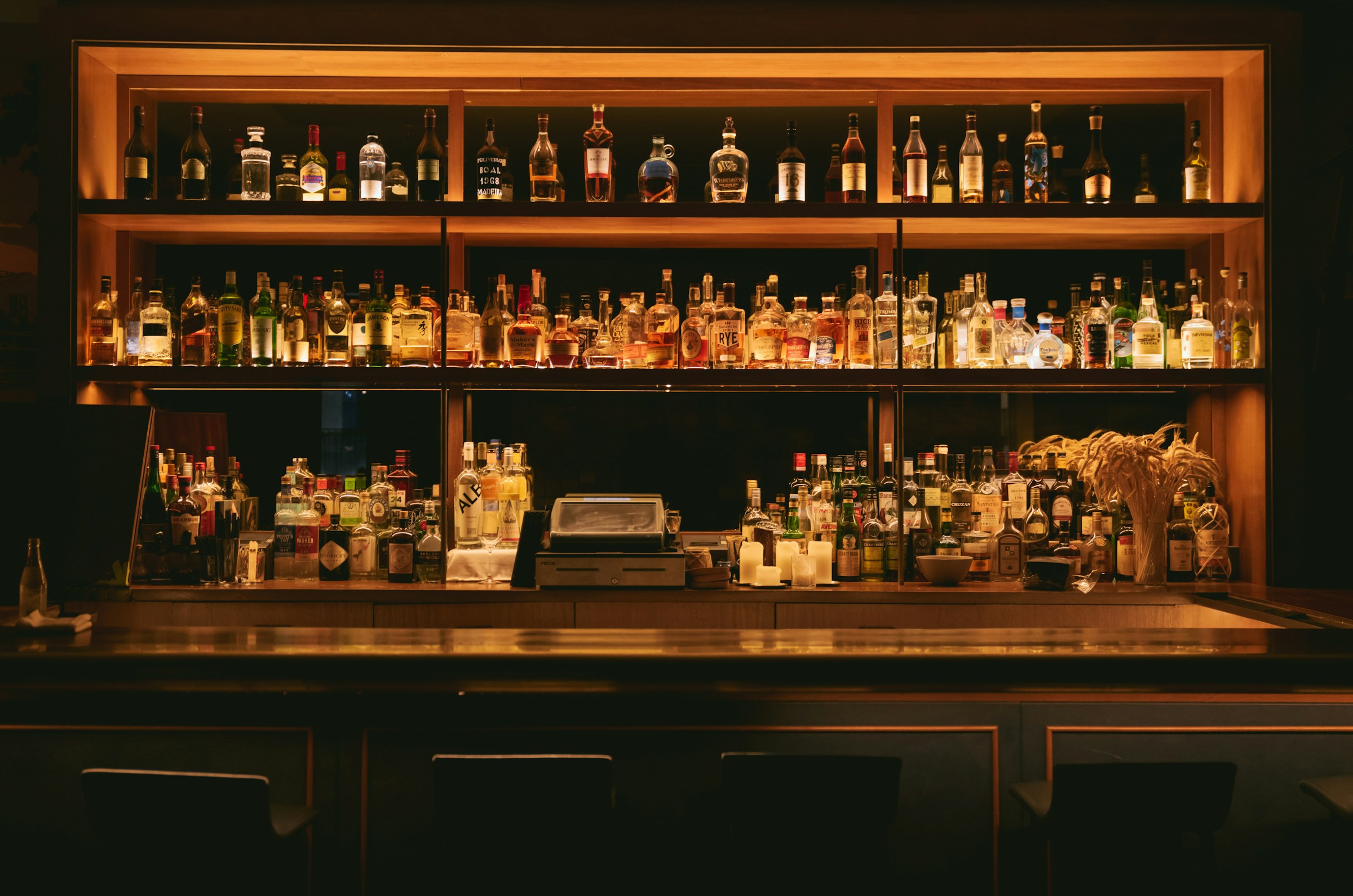 A warmly lit, carefully stocked bar